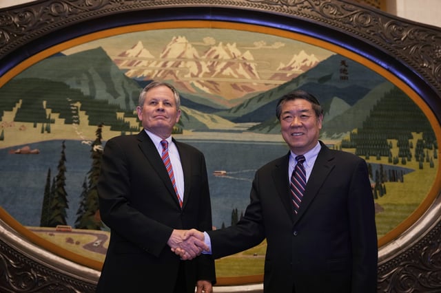 Chinese Vice Premier He Lifeng, right, shakes hands with U.S. Senator Steve Daines before a meeting held in the Xinjiang Room at the Great Hall of the People in Beijing, China, Saturday, March 22, 2025. (AP Photo/Ng Han Guan, Pool)