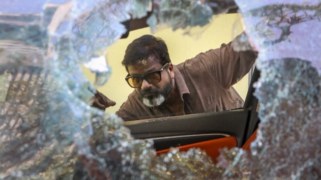A local looks at a vandalised car, a day after violence broke out following an agitation by a right-wing group demanding the removal of Aurangzeb's tomb in Nagpur on March 17, 2025.