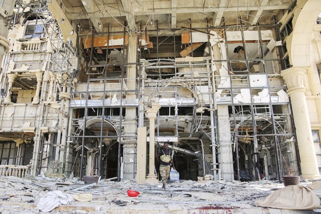 An army soldier walks in front of the damaged Republican Palace in Khartoum, Sudan, after it was taken over by Sudan's army Friday, March 21, 2025. (AP Photo)