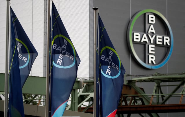FILE PHOTO: Logo and flags of Bayer AG are pictured outside a plant of the German pharmaceutical and chemical maker in Wuppertal, Germany August 9, 2019. REUTERS/Wolfgang Rattay/File Photo