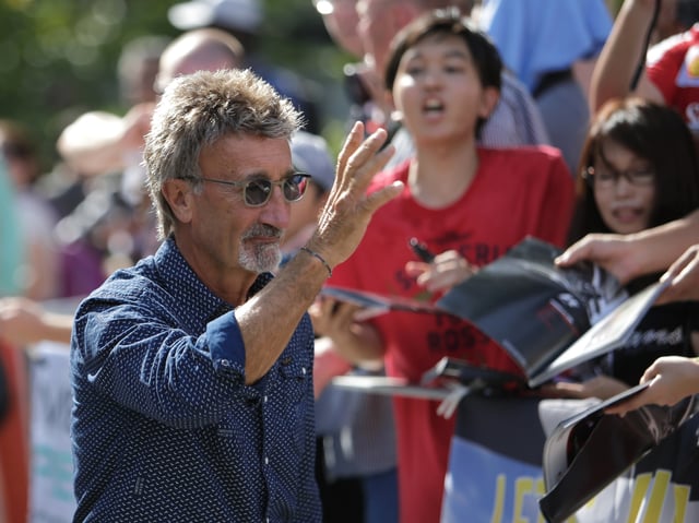 Former race driver Eddie Jordan of Ireland arrives at the track ahead of the third practice session of the Singapore F1 Grand Prix at the Marina Bay street circuit in Singapore September 21, 2013. REUTERS/Tim Chong/File Photo