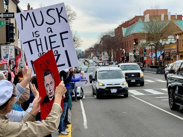 People protest against Elon Musk outside a Tesla dealership in the neighbourhood of Georgetown, in Washington, D.C., U.S., March 22, 2025. REUTERS/Yann Tessier