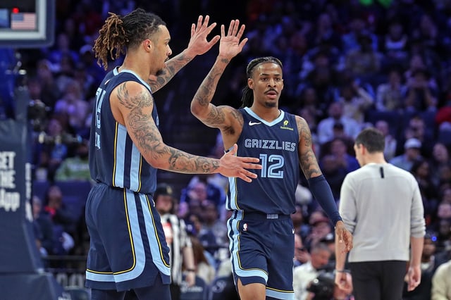 Ja Morant #12 and Brandon Clarke #15 of the Memphis Grizzlies celebrate during the first half against the Oklahoma City Thunder at FedExForum on March 05, 2025 in Memphis, Tennessee.
