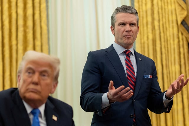 U.S. Defense Secretary Pete Hegseth speaks next to President Donald Trump, in the Oval Office at the White House, in Washington, D.C., U.S., March 21, 2025. REUTERS/Carlos Barria/File Photo