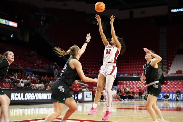 Mar 22, 2025; College Park, Maryland, USA; Alabama Crimson Tide guard Aaliyah Nye (32) takes a shot over multiple Green Bay Phoenix defenders during the second half at Xfinity Center. Daniel Kucin Jr.-Imagn Images