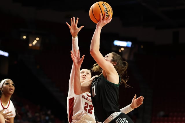 Mar 22, 2025; College Park, Maryland, USA; Green Bay Phoenix guard Natalie McNeal (11) takes a shot over Alabama Crimson Tide guard Karly Weathers (22) during the second half at Xfinity Center. Daniel Kucin Jr.-Imagn Images