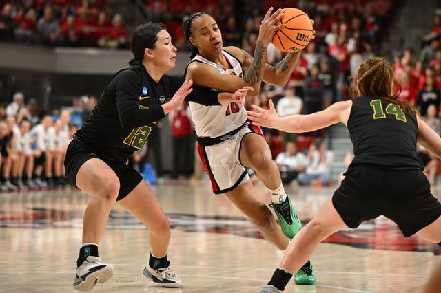 Mar 22, 2025; Raleigh, North Carolina, USA; NC State Wolfpack guard Aziaha James (10) drives against Vermont Catamounts guard Keira Hanson (12) during the second half at James T. Valvano Arena at William Neal Reynolds. William Howard-Imagn Images