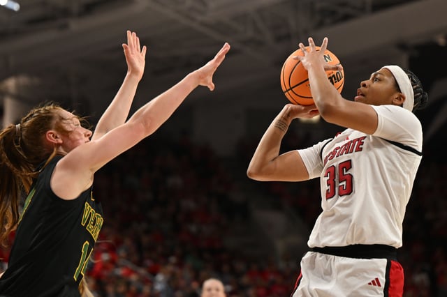 Mar 22, 2025; Raleigh, North Carolina, USA; NC State Wolfpack guard Zoe Brooks (35) shoots over Vermont Catamounts guard Catherine Gilwee (14) during the second half at James T. Valvano Arena at William Neal Reynolds. William Howard-Imagn Images