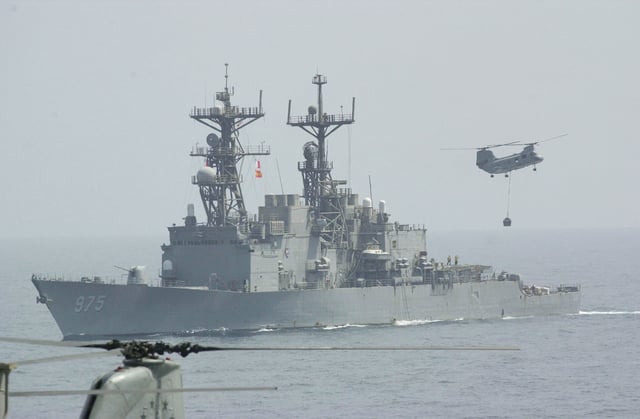 U.S. Navy Spruance Class destroyer USS O&#39;Brien (DD 975) receiving a load of palatized cargo for delivery to other ships in the battle group.