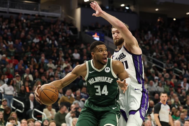 Giannis Antetokounmpo #34 of the Milwaukee Bucks is defended by Domantas Sabonis #11 of the Sacramento Kings during the first half of a game at Fiserv Forum on January 14, 2025 in Milwaukee, Wisconsin.