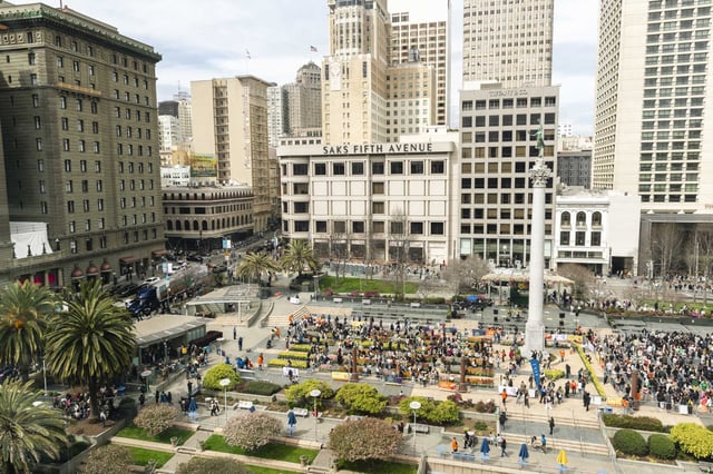 Crowds wait in long lines to select free flowers during Tulip Day in Union Square.