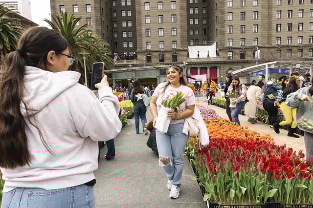 Nicole Fernandez, right, poses for a photo during Tulip Day in San Francisco. 