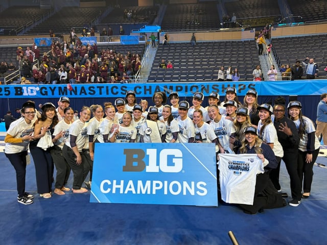 Members of UCLA gymnastics celebrate with the Big Ten championship trophy Saturday in Ann Arbor, Mich. at the Crisler Center on Saturday, March 22, 2025. (UCLA Athletics)