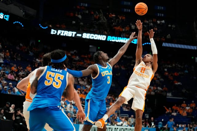 Tennessee guard Jordan Gainey (11) shoots the ball against UCLA guard Eric Dailey Jr. (3) during the second half in the second round of the NCAA college basketball tournament, Saturday, March 22, 2025, in Lexington, Ky. (AP Photo/Brynn Anderson)