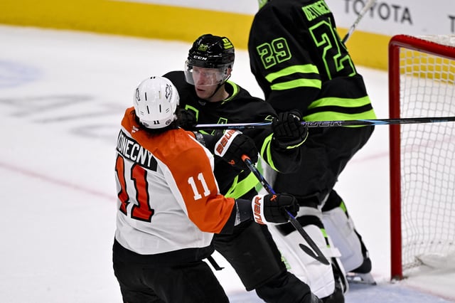 Mar 22, 2025; Dallas, Texas, USA; Dallas Stars defenseman Esa Lindell (23) checks Philadelphia Flyers right wing Travis Konecny (11) during the third period at the American Airlines Center. Mandatory Credit: Jerome Miron-Imagn Images