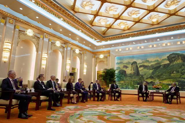U.S. Senator Steve Daines, leads a delegation of U.S. business leaders, Boeing Global Senior VP Brendan Nelson, Pfizer CEO Albert Bourla, Cargill CEO Brian Sikes, UL Solutions CEO Jennifer Scanlon, Medtronic CEO Geoffrey Martha, Qualcomm CEO Cristiano Amon and FedEx CEO Raj Subramaniam during a meeting with Chinese Premier Li Qiang at right in the Fujian Room at the Great Hall of the People in Beijing, China, Sunday, March 23, 2025.     Ng Han Guan/Pool via REUTERS