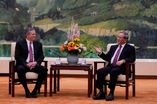 Chinese Premier Li Qiang, right, meets U.S. Senator Steve Daines in the Fujian Room at the Great Hall of the People in Beijing, China, Sunday, March 23, 2025.     Ng Han Guan/Pool via REUTERS