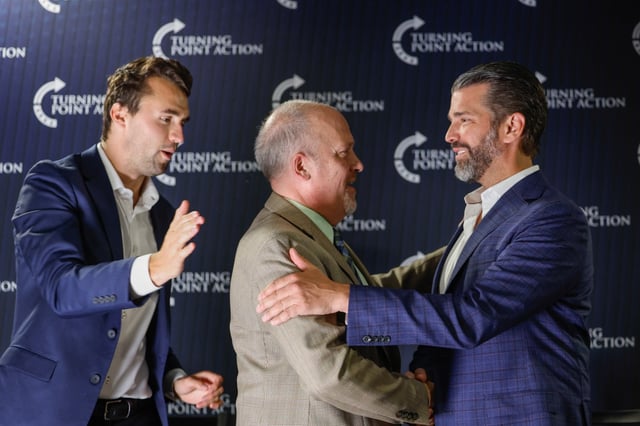Wisconsin Supreme Court candidate and former Wisconsin Attorney General Brad Schimel, center, greets Donald Trump Jr., right, with Charlie Kirk during a town hall March 17, 2025, in Oconomowoc, Wisconsin. (Jeffrey Phelps/AP)