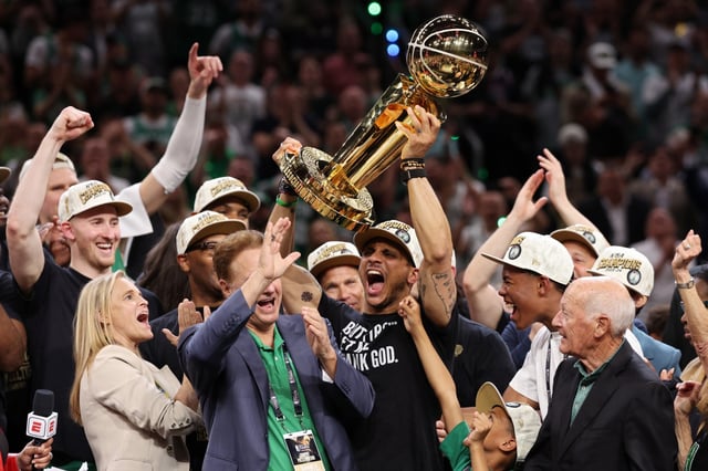 Boston Celtics Head Coach Joe Mazzulla yells while lifting the Larry O’Brien Championship Trophy after Boston&#39;s 106-88 win against the Dallas Mavericks in Game 5 of the 2024 NBA Finals.