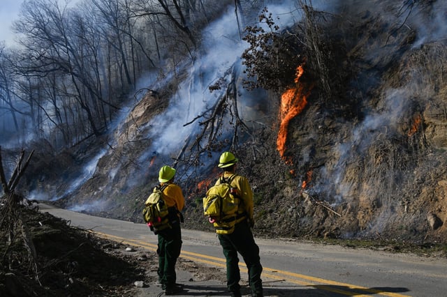 Firefighters work to put out wildfires in Tryon, N.C., on March 3, 2025.