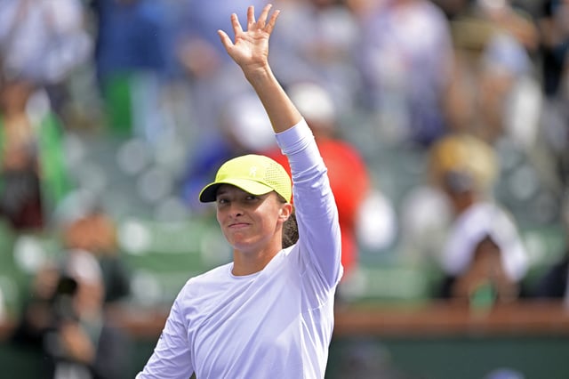 Mar 11, 2025; Indian Wells, CA, USA; Iga Swiatek (POL) waves to the crowd after she defeated Karolina Muchova (not pictured) during her fourth round match in the BNP Paribas Open the at Indian Well Tennis Garden. Jayne Kamin-Oncea-Imagn Images