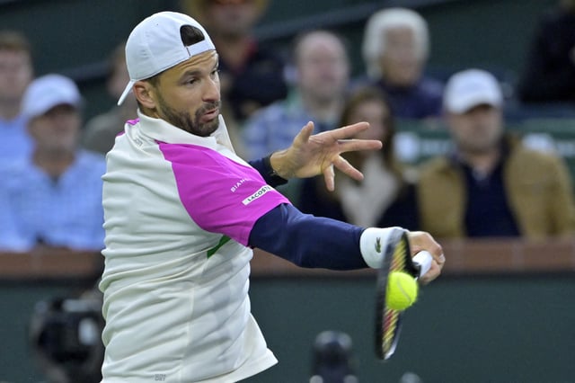 Mar 12, 2025; Indian Wells, CA, USA;  Grigor Dimitrov (BUL) hits a shot against Carlos Alcaraz (not pictured) in the fourth round of the BNP Paribas Open at the Indian Well Tennis Garden. Jayne Kamin-Oncea-Imagn Images