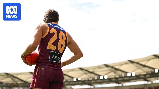 Will McLachlan of the Brisbane Lions stands on the Gabba with his hands on his hips.