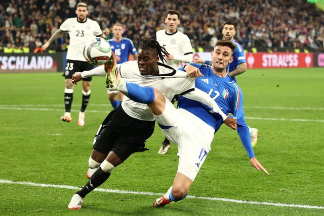Soccer Football - Nations League - Quarter Final - Second Leg - Germany v Italy - Signal Iduna Park, Dortmund, Germany - March 23, 2025 Germany's Yann Bisseck in action with Italy's Lorenzo Lucca REUTERS/Leon Kuegeler