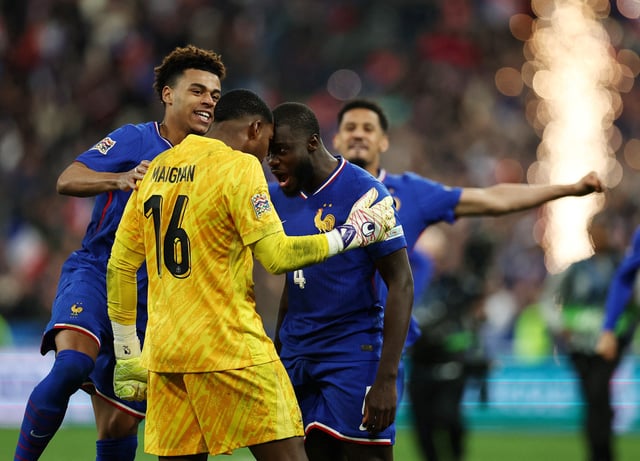Soccer Football - Nations League - Quarter Final - Second Leg - France v Croatia - Stade de France, Saint-Denis, France - March 23, 2025 France's Dayot Upamecano celebrates with Mike Maignan after scoring the winning penalty in the shootout REUTERS/Sarah Meyssonnier