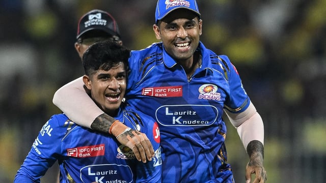 Mumbai Indians' Vignesh Puthur (L) celebrates with his captain Suryakumar Yadav after taking the wicket of Chennai Super Kings' Shivam Dube 