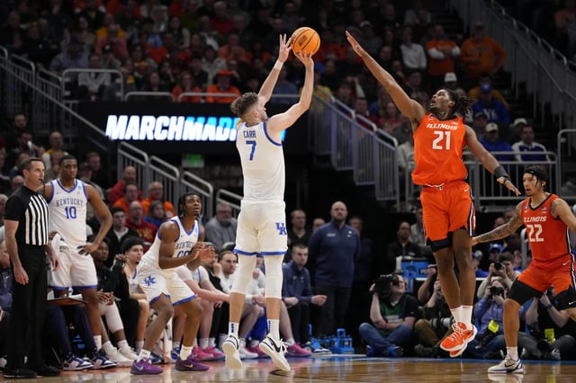 Mar 23, 2025; Milwaukee, WI, USA;  Kentucky Wildcats forward Andrew Carr (7) shoots against Illinois Fighting Illini forward Morez Johnson Jr. (21) during the second half in the second round of the NCAA Tournament at Fiserv Forum. Mandatory Credit: Jeff Hanisch-Imagn Images
