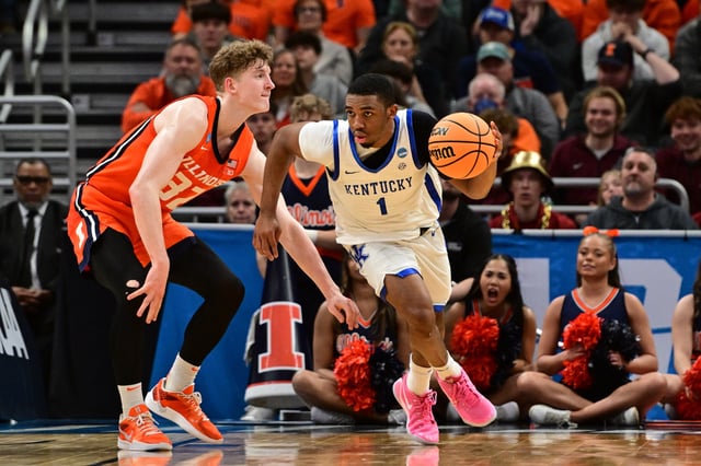 Mar 23, 2025; Milwaukee, WI, USA;  Kentucky Wildcats guard Lamont Butler (1) dribbles against Illinois Fighting Illini guard Kasparas Jakucionis (32) during the second half in the second round of the NCAA Tournament at Fiserv Forum. Mandatory Credit: Benny Sieu-Imagn Images