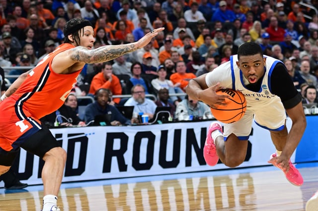 Mar 23, 2025; Milwaukee, WI, USA;  Kentucky Wildcats guard Lamont Butler (1) goes down against Illinois Fighting Illini guard Tre White (22) during the second half in the second round of the NCAA Tournament at Fiserv Forum. Mandatory Credit: Benny Sieu-Imagn Images