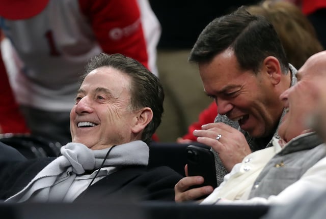 St. John’s coach Rick Pitino, left, is all smiles as he watches his son, New Mexico Lobos coach Richard Pitino, during an NCAA Tournament second-round game March 23, 2025, in Cleveland, Ohio.