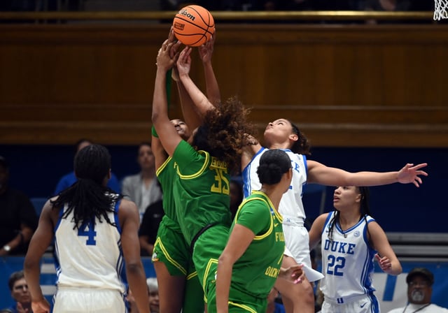Mar 23, 2025; Durham, NC, USA; Duke Blue Devils forward Delaney Thomas (12) battles with Oregon Ducks forward Ehis Etute (35) for a loose ball during the second half at Cameron Indoor Stadium. The Blue Devils won 59-53. Mandatory Credit: Rob Kinnan-Imagn Images