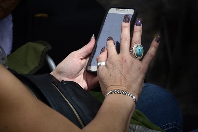 (File Photo) A woman uses her Samsung smartphone in Santa Fe, New Mexico.