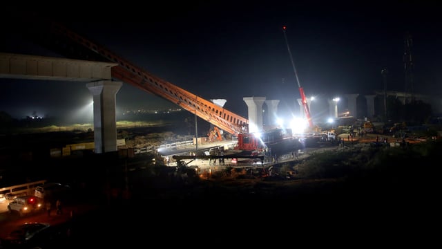 Restoration work underway after a segmental launching gantry (crane) skidded and fell near Vatva-Ropda Road, in Ahmedabad