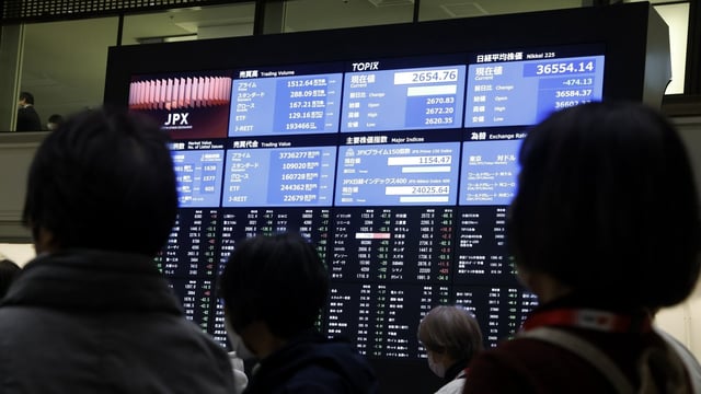 Visitors in front of an electronic stock board at the Tokyo Stock Exchange (TSE) in Tokyo, Japan, on Tuesday, March 11, 2025.