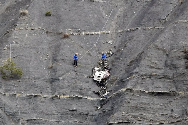 FILE - Rescue workers work at the crash site after a Germanwings plane crashed over the French Alps near Seyne-les-Alpes, France, Monday, March 30, 2015. (AP Photo/Claude Paris, Pool, File)