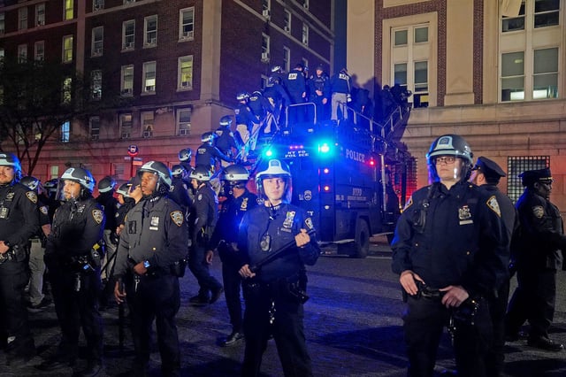 Police use a special vehicle to enter Hamilton Hall, which protesters occupied, as other officers enter the campus of Columbia University in New York on April 30, 2024.