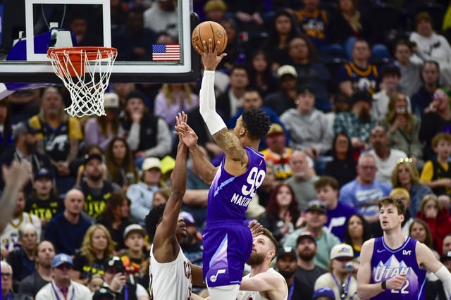 Mar 23, 2025; Salt Lake City, Utah, USA; Utah Jazz forward KJ Martin (99) makes a shot over Cleveland Cavaliers forward/guard De'Andre Hunter (12) and Cleveland Cavaliers forward/center Dean Wade (32) during the second half at Delta Center. Mandatory Credit: Peter Creveling-Imagn Images