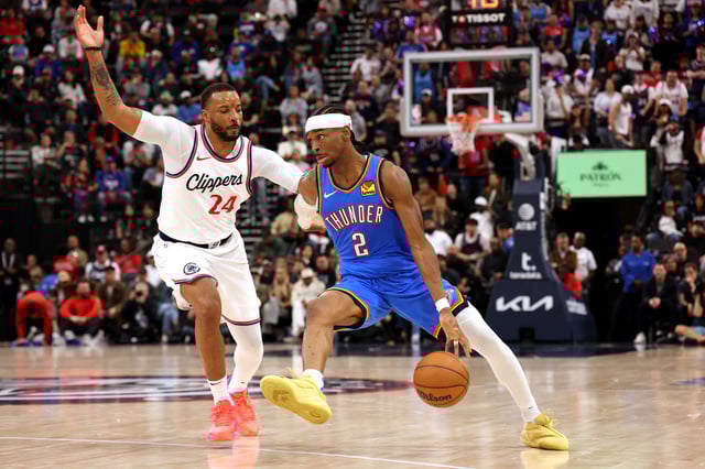 Mar 23, 2025; Inglewood, California, USA; Oklahoma City Thunder guard Shai Gilgeous-Alexander (2) drives against LA Clippers guard Norman Powell (24) during the 4th quarter at Intuit Dome. Mandatory Credit: Jason Parkhurst-Imagn Images