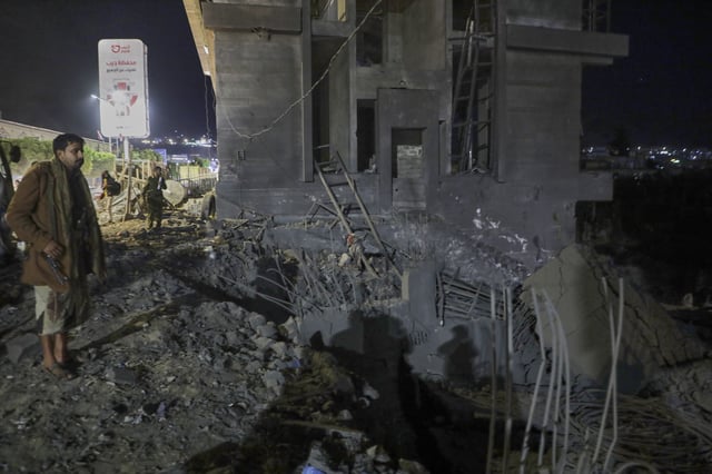 A Yemeni views the debris of a building after it was struck by U.S. airstrikes in Sanaa, Yemen, Monday, March 24, 2025. (AP Photo)