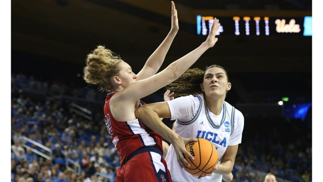 UCLA center Lauren Betts drives to the basket as Richmond’s Addie Budnik defends during the second half of their NCAA Tournament second-round game on Sunday night at Pauley Pavilion. Betts scored 30 points (on 14-of-17 shooting from the field) and grabbed 14 rebounds as the Bruins rode a dominant third quarter to an 84-67 win. (Photo by Katharine Lotze/Getty Images)