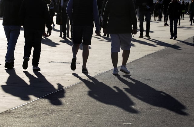 People walk on the Promenade des Anglais in Nice, France March 15, 2020. REUTERS/Eric Gaillard/File Photo