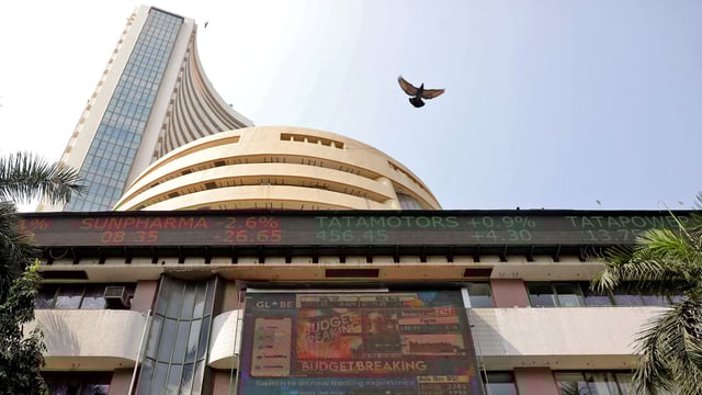 Stock market rally: A bird flies past a screen displaying the Sensex results on the facade of the Bombay Stock Exchange (BSE) building in Mumbai.