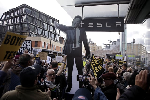 People participate in a &#34;TeslaTakedown&#34; protest against Elon Musk outside of a Tesla dealership in New York, March 1, 2025.