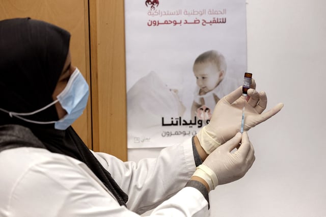 A nurse prepares a doze of measles vaccine at a hospital in the Moroccan coastal city of Temara on February 27, 2025. Authorities in Morocco have been scrambling to contain an outbreak of measles, a contagious and potentially fatal disease that had nearly been eradicated in the kingdom but has rebounded as vaccination rates have fallen. (Photo by Abdel Majid BZIOUAT / AFP) (Photo by ABDEL MAJID BZIOUAT/AFP via Getty Images)          