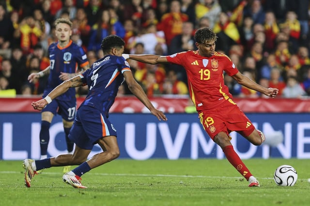 Spain's Lamine Yamal, right, scores his side third goal during the UEFA Nations League quarterfinal second leg match between the Netherlands and Spain at Mestalla stadium in Valencia, Spain, Sunday, March 23, 2025. (AP Photo/Alberto Saiz)