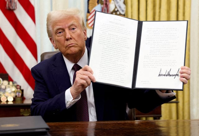 President Donald Trump holds a signed executive order on cryptocurrencies, in the Oval Office of the White House, in Washington, on Jan. 23, 2025.